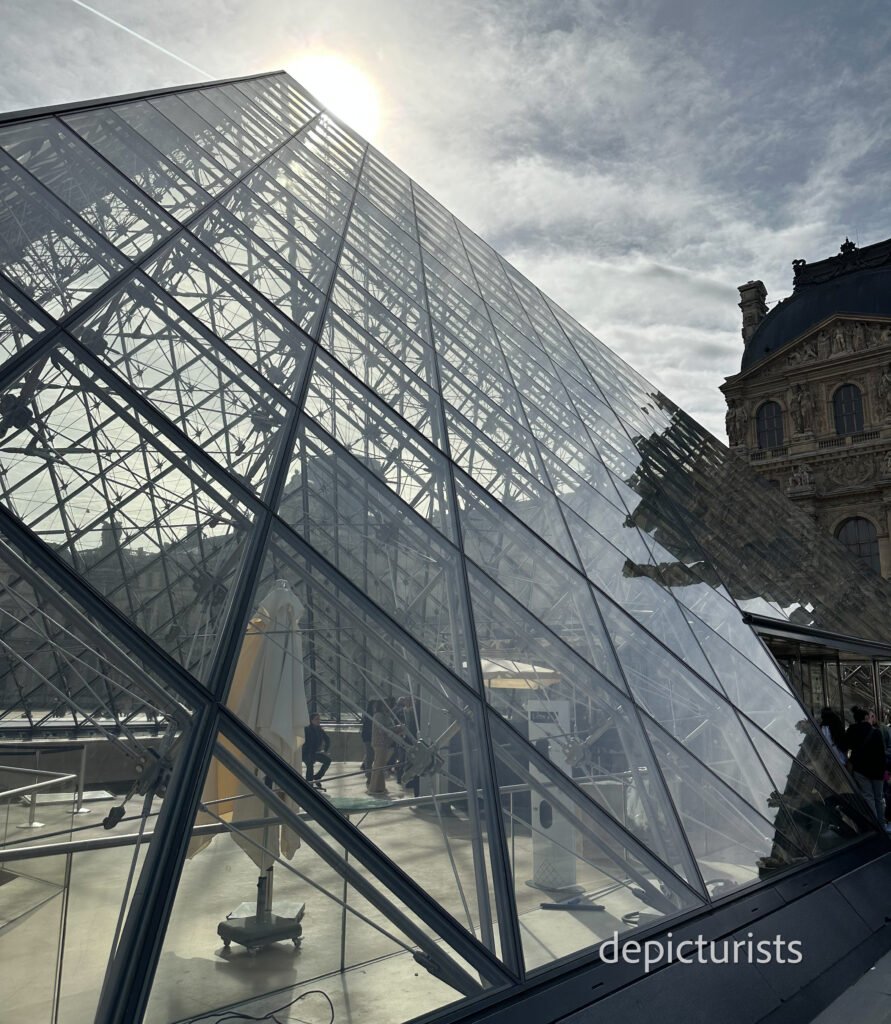 iconic glass pyramid at the entrance-The Louvre's architecture